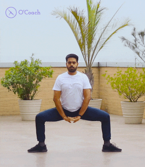 Boy is performing Utkatasana Wide Chair Pose