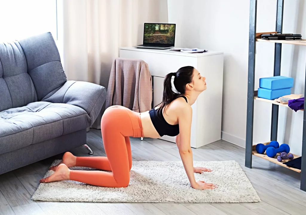 Girl is doing Cat-Cow effective stretches for lower back