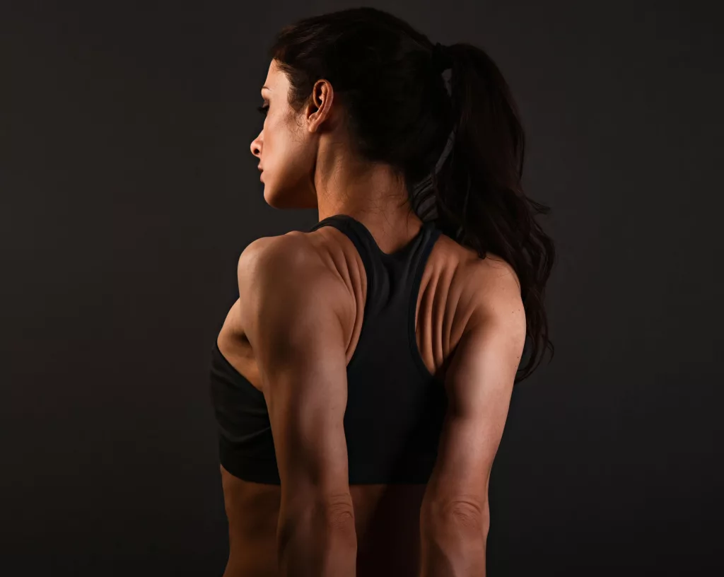 Girl doing Shoulder Blade Squeezes to improve her slouch posture