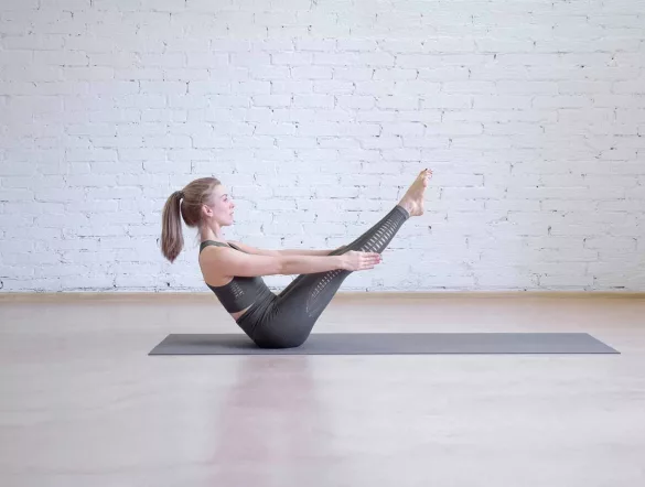 girl is doing boat pose workout