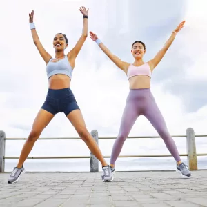 Two Girls doing jumping jacks