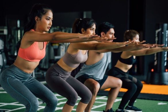 Women doing HIIT workout in gym, mid motion, athletic wear, energetic